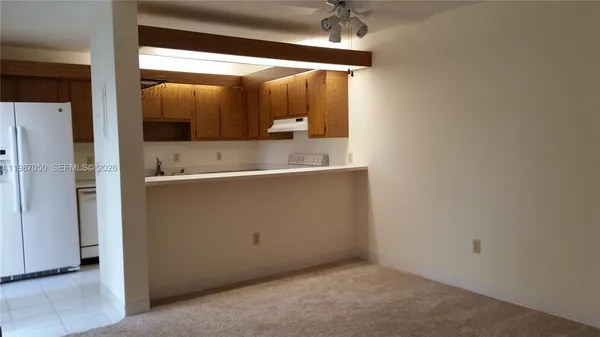 an empty room with a bathroom and a mirror