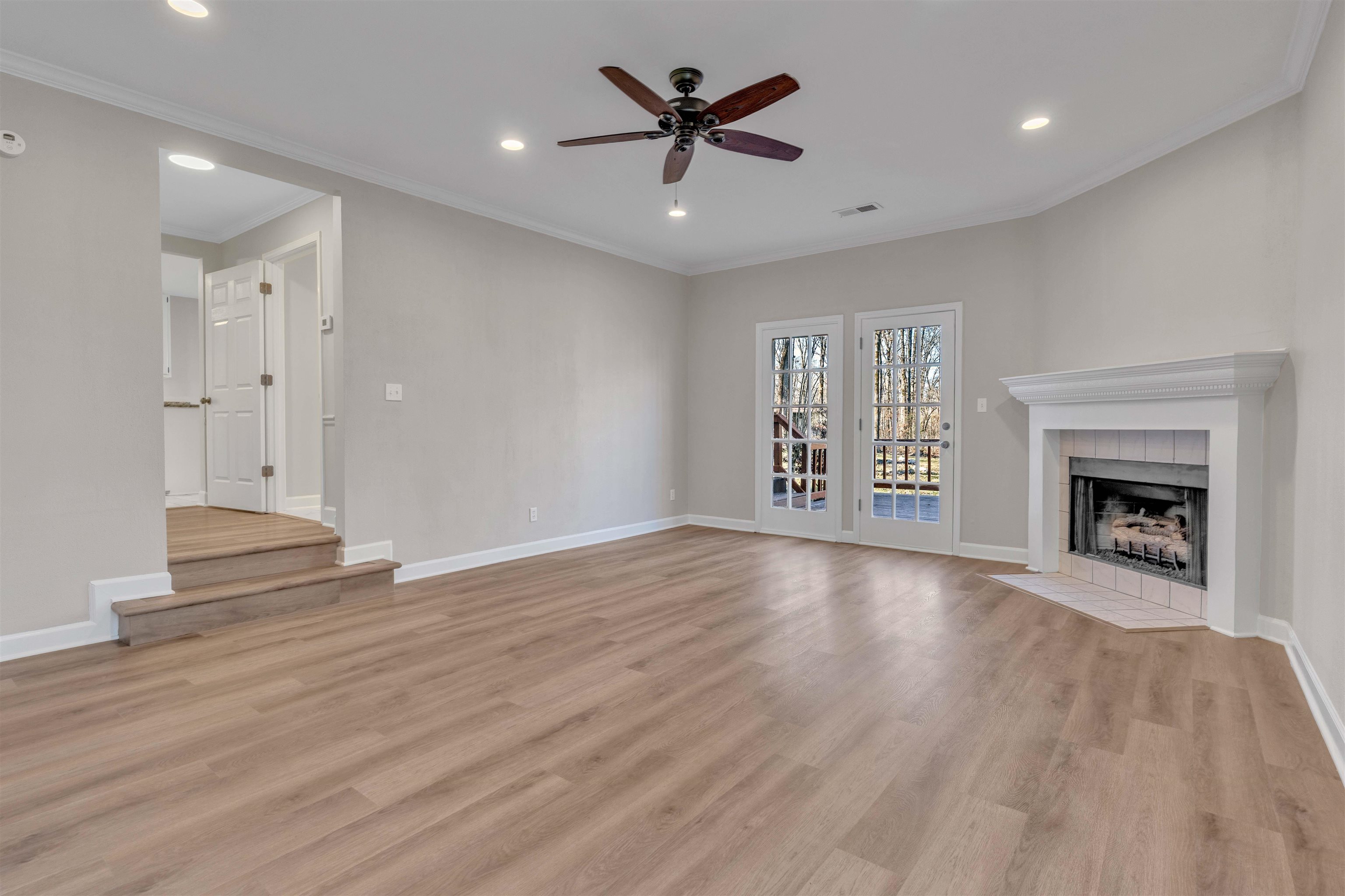 310 Walnut Bend Road Arlington, TN 38002 - Photo 3 of 40 an empty room with windows and a fireplace