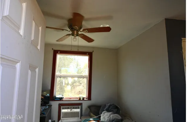 a room with a window and a chandelier