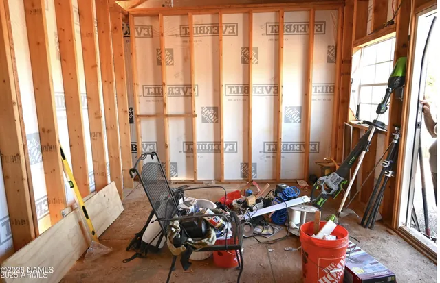 a view of a room with lots of furniture and windows