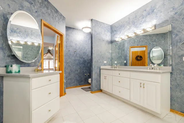 a spacious bathroom with a double vanity sink and a mirror