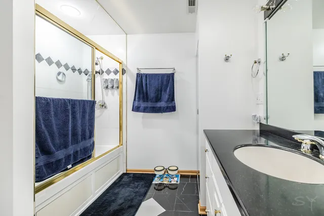 a bathroom with a sink and mirror