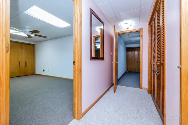 a view of a hallway with wooden shelves