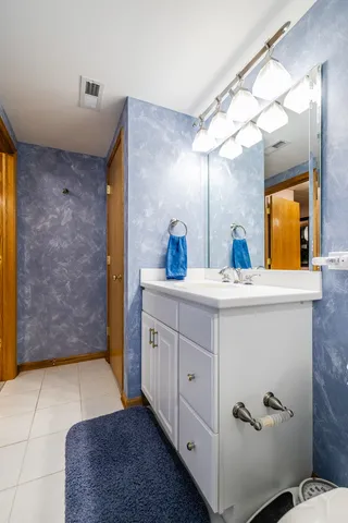 a bathroom with a double vanity sink mirror and shower