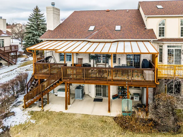 a view of a house with pool and chairs
