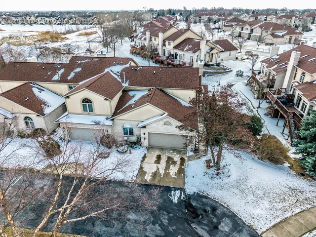 an aerial view of residential houses with outdoor space