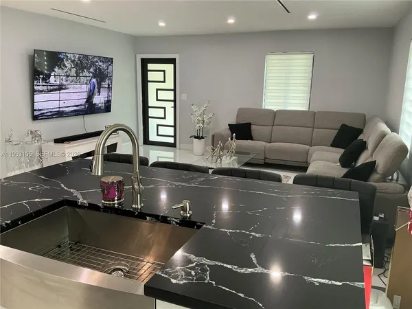 a kitchen with a large window cabinets and stainless steel appliances