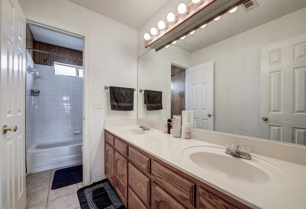 365 Country Lane Haslet, TX 76052 - Photo 16 of 34 a bathroom with double vanity and a mirror