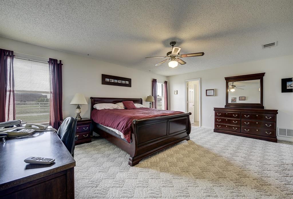 365 Country Lane Haslet, TX 76052 - Photo 18 of 34 a bedroom with a bed dresser and a window