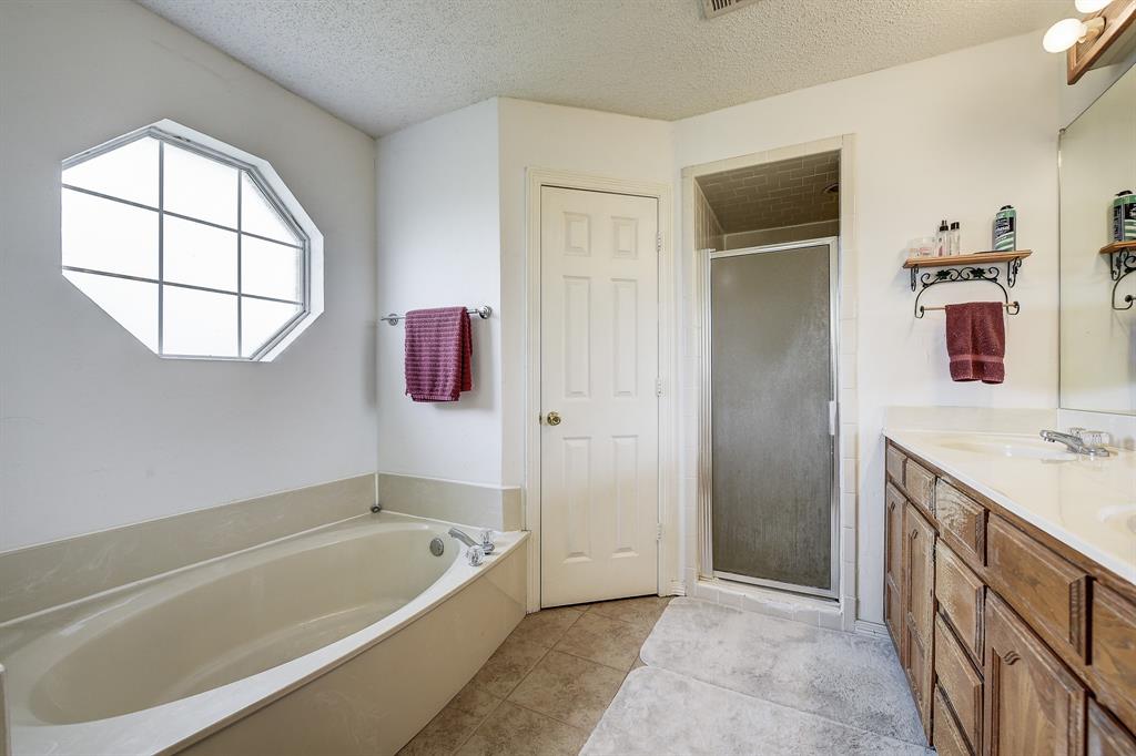 365 Country Lane Haslet, TX 76052 - Photo 20 of 34 a bathroom with a tub sink and mirror