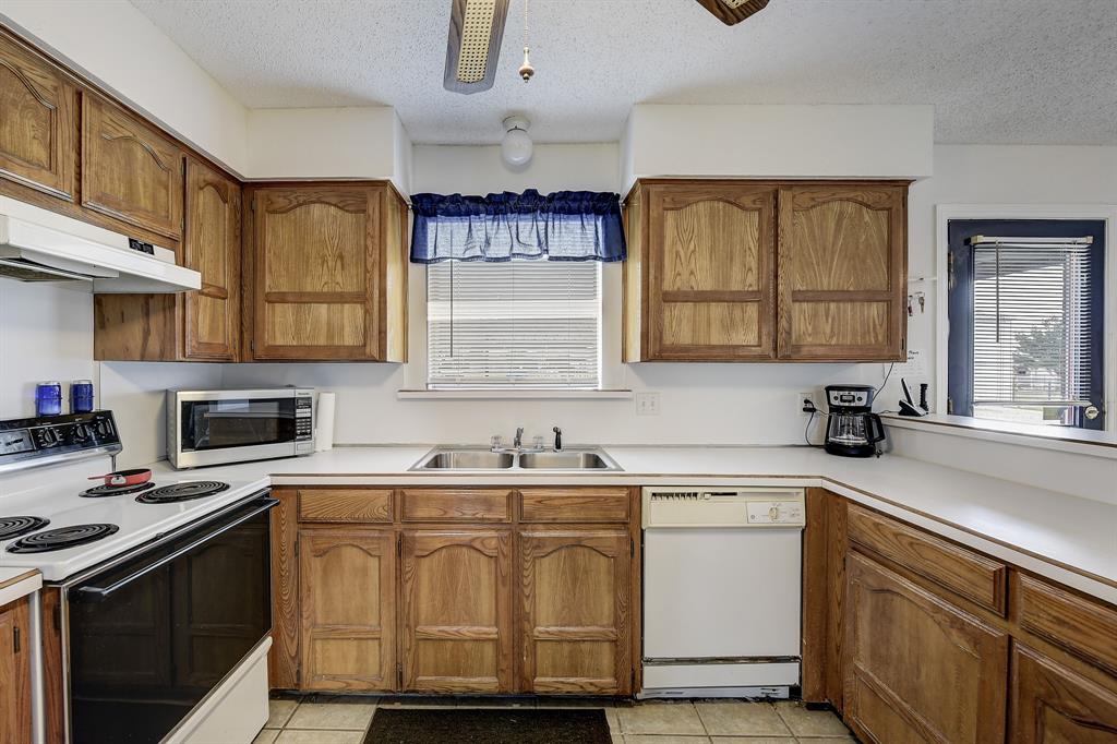 365 Country Lane Haslet, TX 76052 - Photo 9 of 34 a kitchen with cabinets appliances a sink and a window