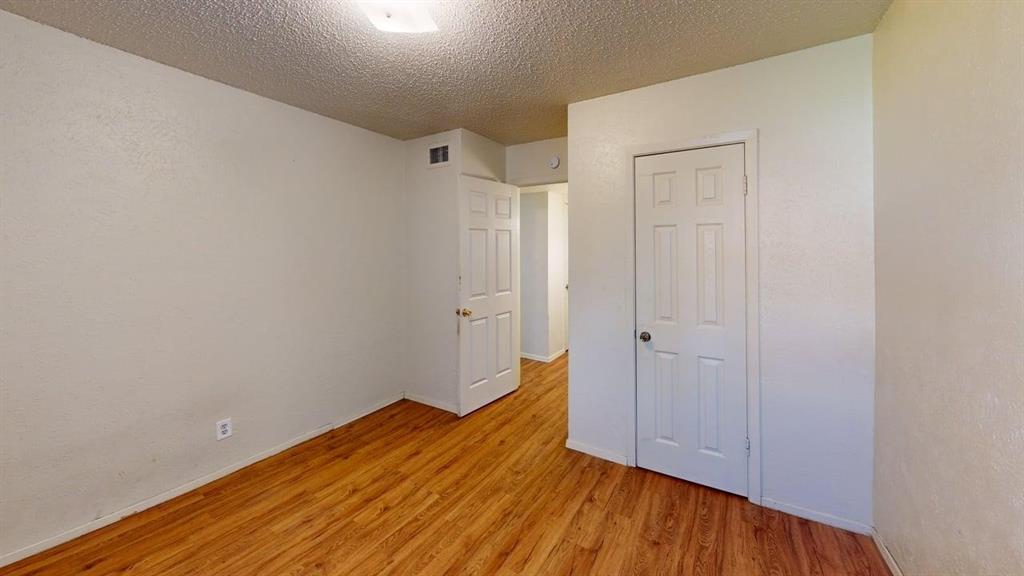 410 Bryan Street, Unit 17 Denton, TX 76201 - Photo 11 of 14 a view of empty room with wooden floor and entryway