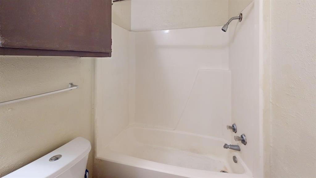 410 Bryan Street, Unit 17 Denton, TX 76201 - Photo 13 of 14 a bathroom with a bathtub and a shower