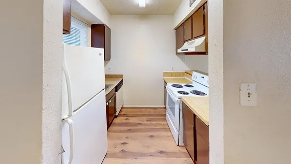 a white refrigerator freezer sitting inside of a kitchen