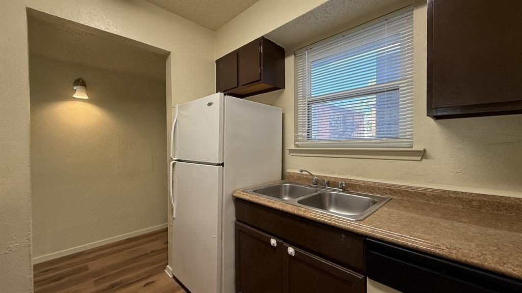 410 Bryan Street, Unit 17 Denton, TX 76201 - Photo 5 of 14 a white refrigerator freezer sitting inside of a kitchen