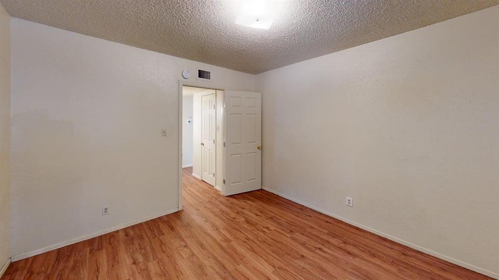 410 Bryan Street, Unit 17 Denton, TX 76201 - Photo 9 of 14 a view of an empty room with wooden floor