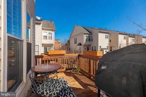 a balcony with table and chairs