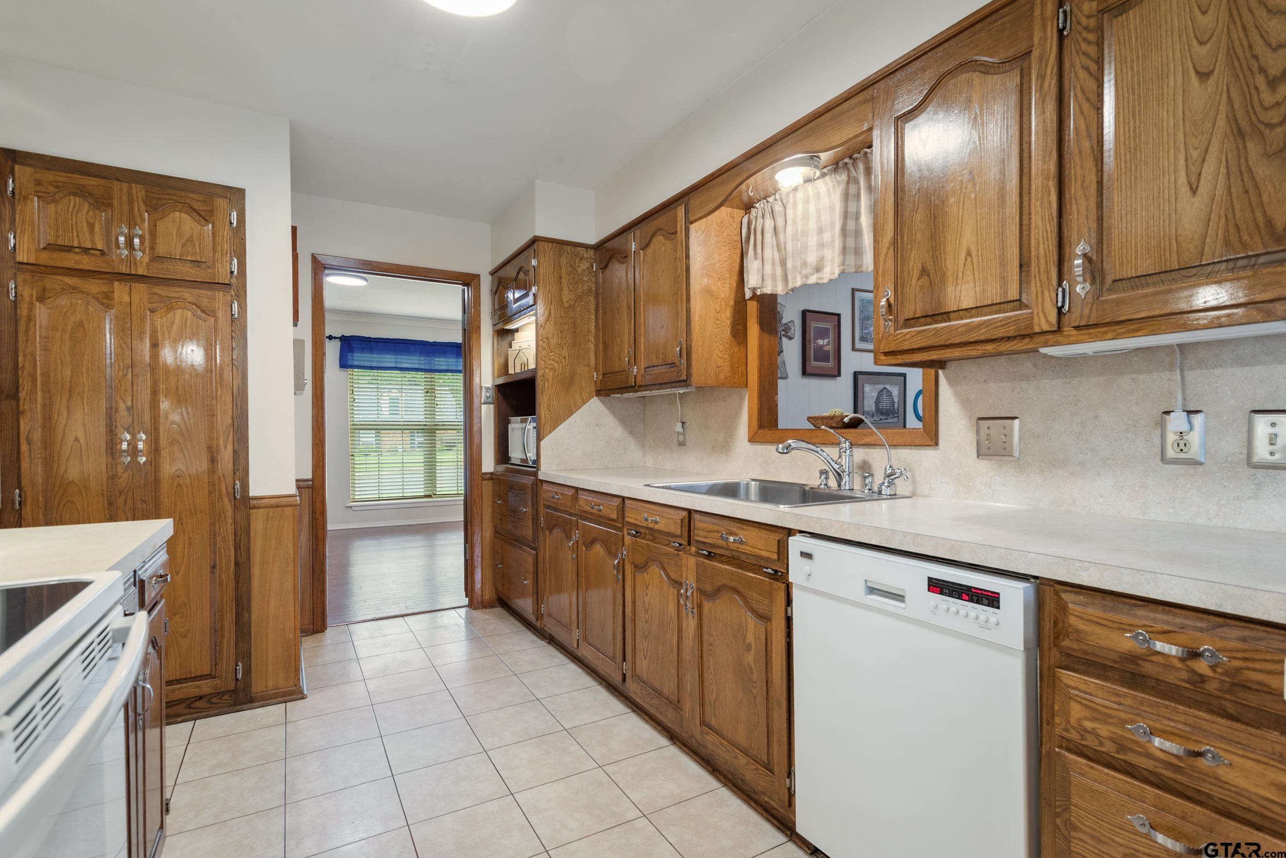 516 Ruthlynn Drive Longview, TX 75605 - Photo 11 of 34 a kitchen with stainless steel appliances granite countertop a sink and a refrigerator