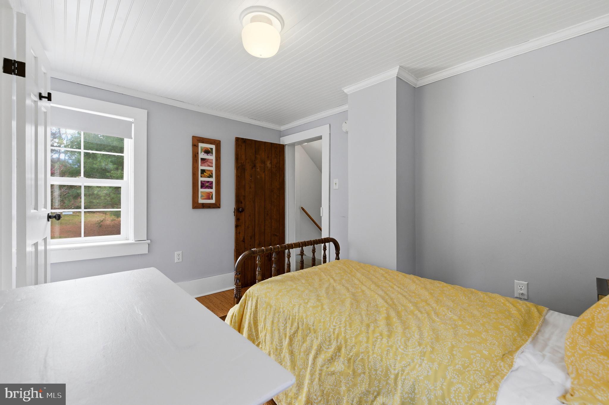 769 Rocky Branch Road Luray, VA 22835 - Photo 37 of 94 a bed sitting in a bedroom next to a window