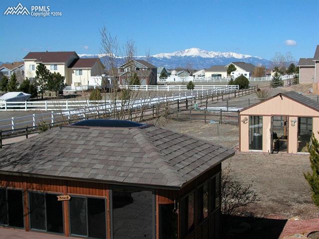 12153 Rio Secco Road Peyton, CO 80831 - Photo 26 of 26 Amazing views of Pikes Peak from the upper level deck. Also shows more of the details on the gazebo & green house