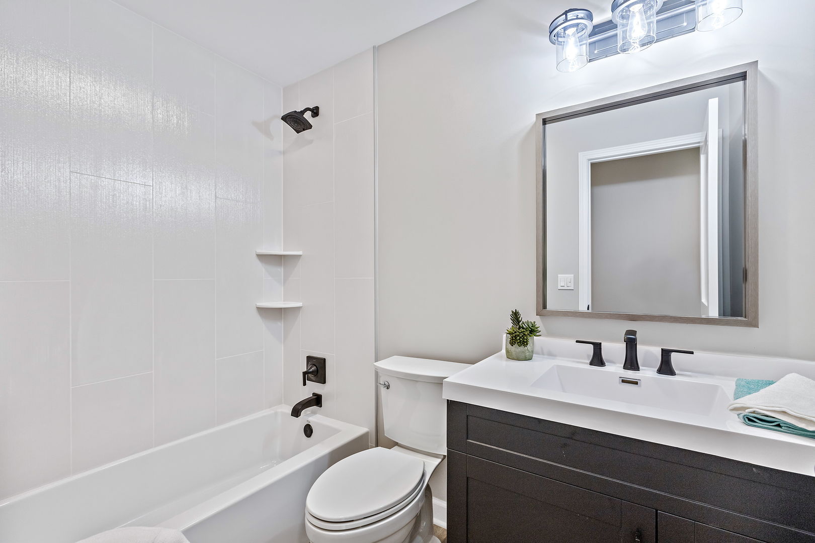 1044 Greenridge Road Buffalo Grove, IL 60089 - Photo 11 of 19 a bathroom with a sink a toilet a mirror and shower