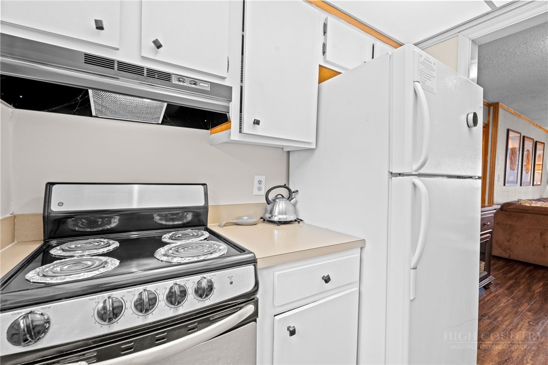 220 Northridge Road, Unit 7 Beech Mountain, NC 28604 - Photo 12 of 22 a white stove top oven sitting inside of a kitchen