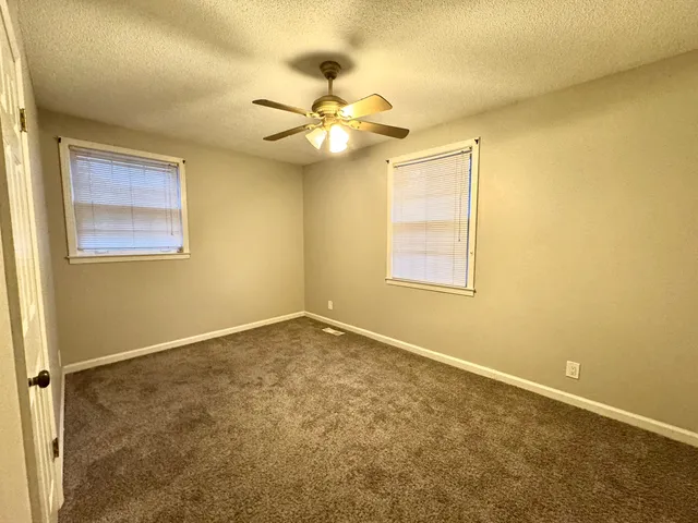 a bathroom with a sink a toilet and shower curtain