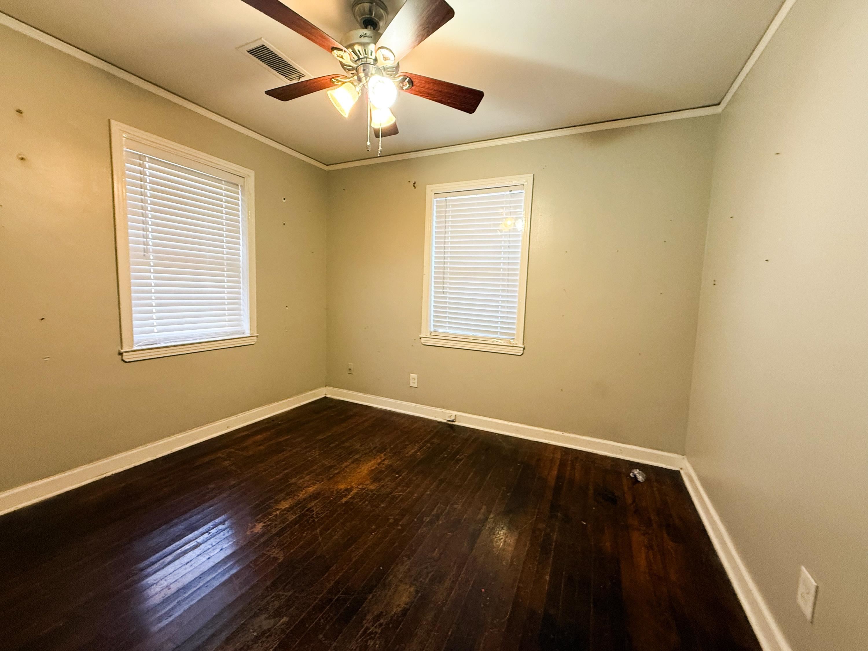 1027 Waring Road Memphis, TN 38122 - Photo 13 of 14 Spare room with dark wood-style flooring, ceiling fan, and ornamental molding
