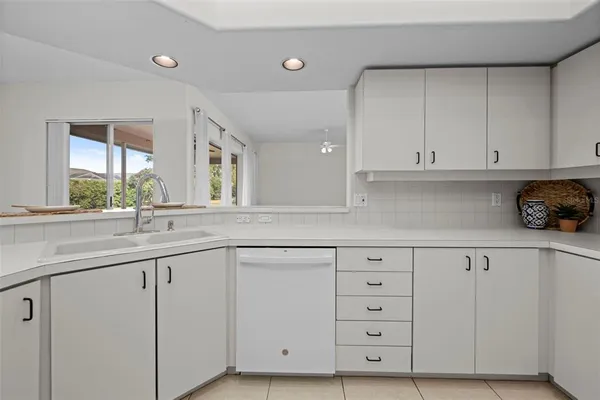 a bathroom with a granite countertop sink a mirror and a bathtub