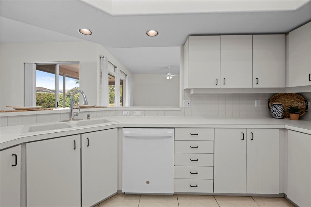 9369 Ashley Drive Weeki Wachee, FL 34613 - Photo 17 of 80 a kitchen with white cabinets and a sink