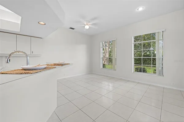 a view of empty room with wooden floor and window