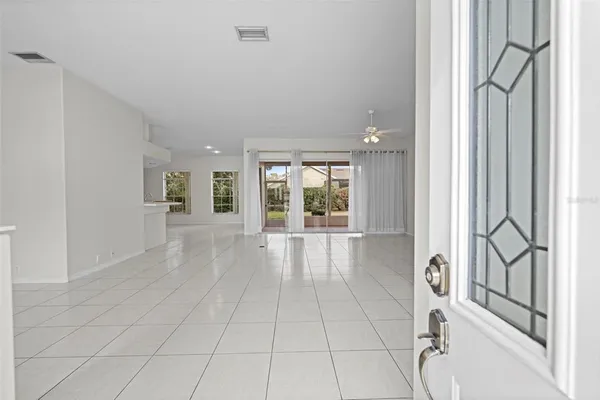 an empty room with entrance and windows