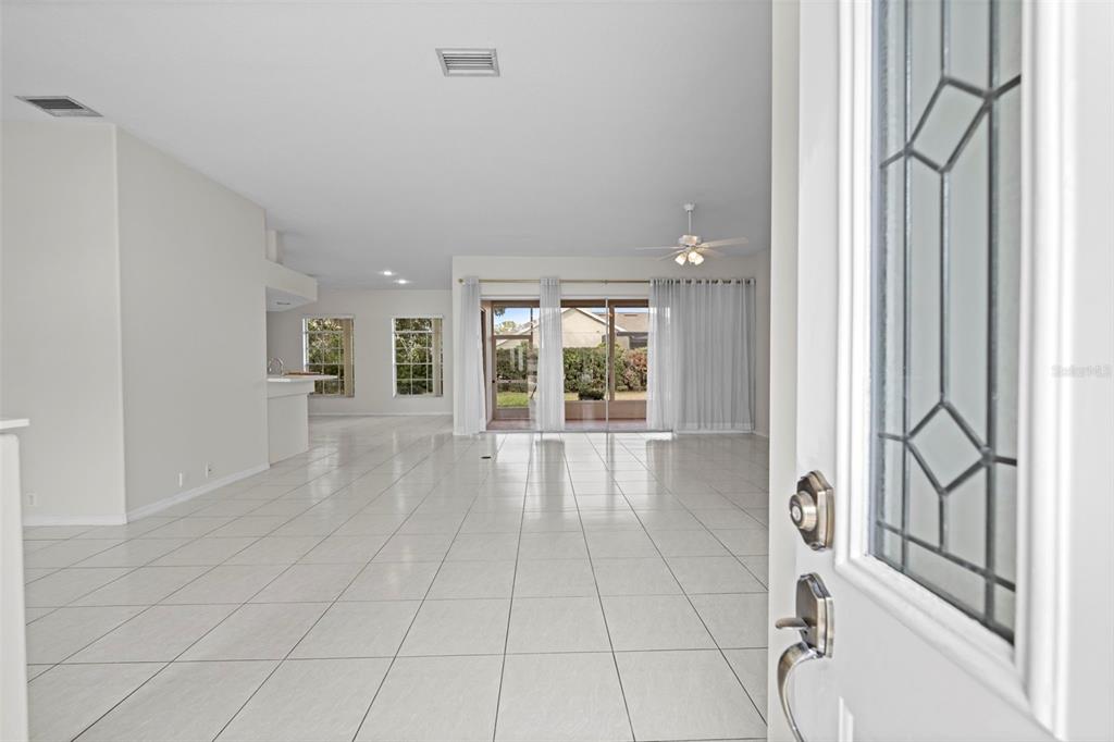9369 Ashley Drive Weeki Wachee, FL 34613 - Photo 2 of 80 a view of an entryway with wooden floor and a living room