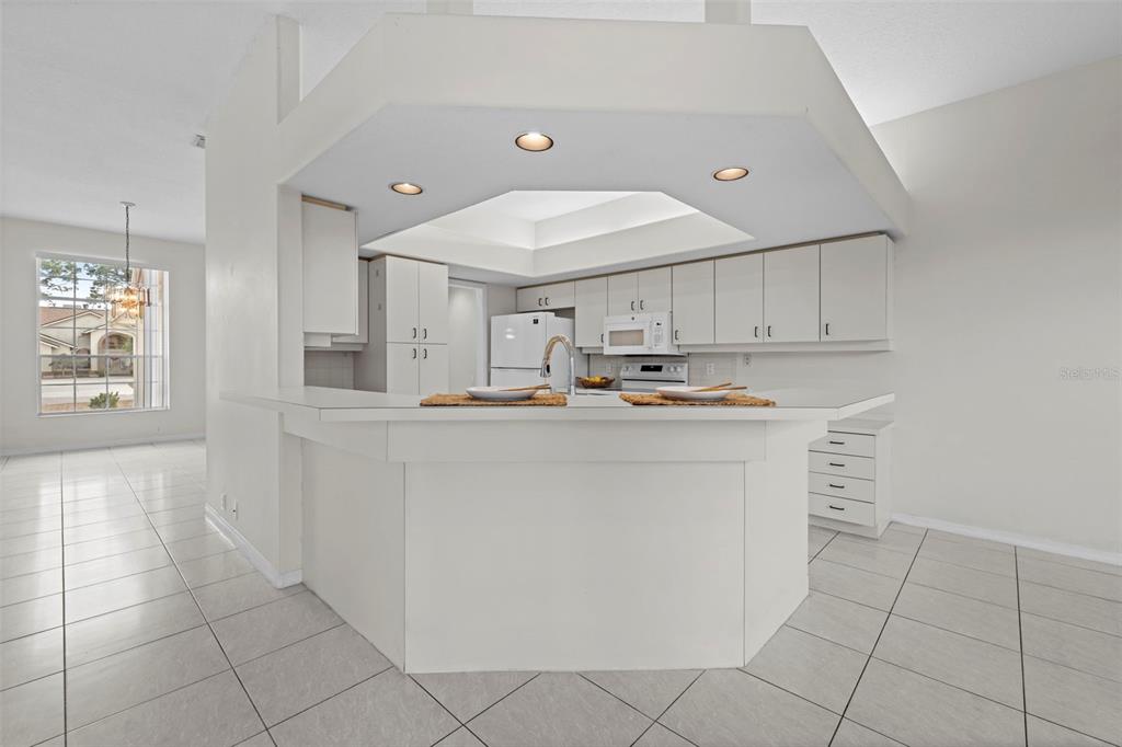 9369 Ashley Drive Weeki Wachee, FL 34613 - Photo 21 of 80 a kitchen with cabinets and stainless steel appliances