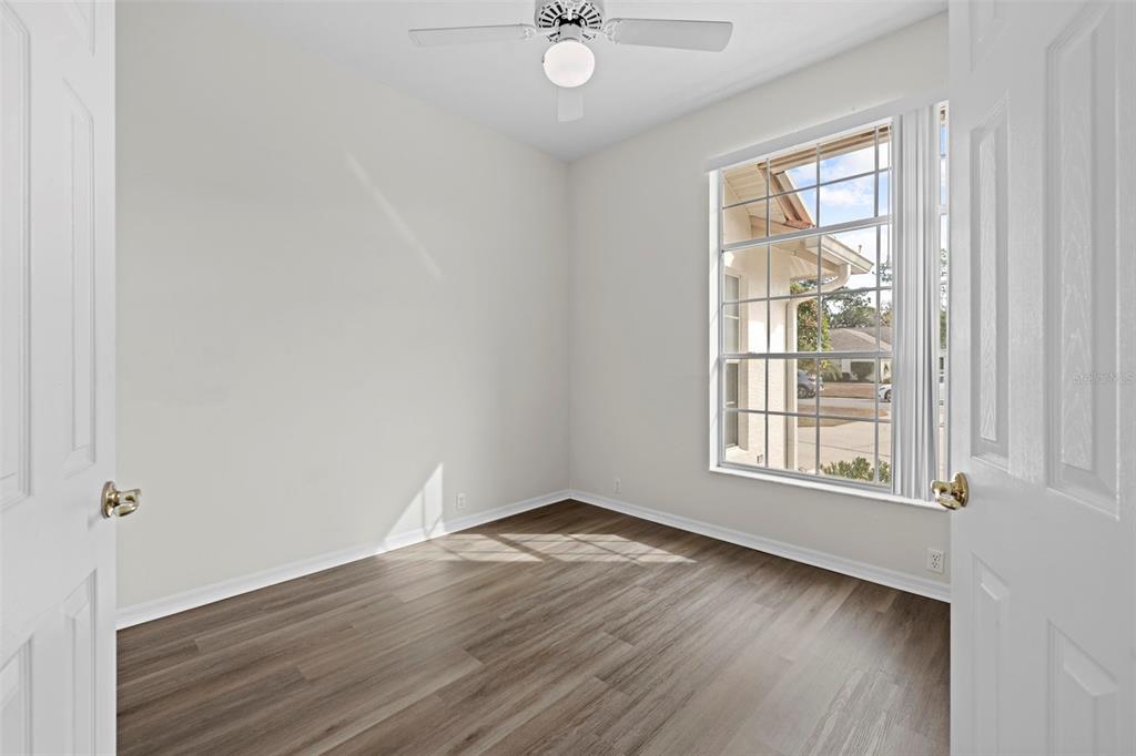 9369 Ashley Drive Weeki Wachee, FL 34613 - Photo 24 of 80 an empty room with wooden floor and windows