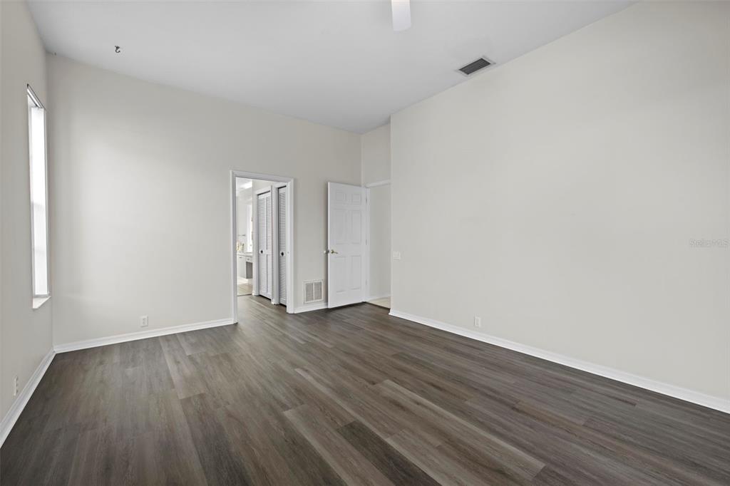 9369 Ashley Drive Weeki Wachee, FL 34613 - Photo 26 of 80 a view of an empty room with wooden floor and a window