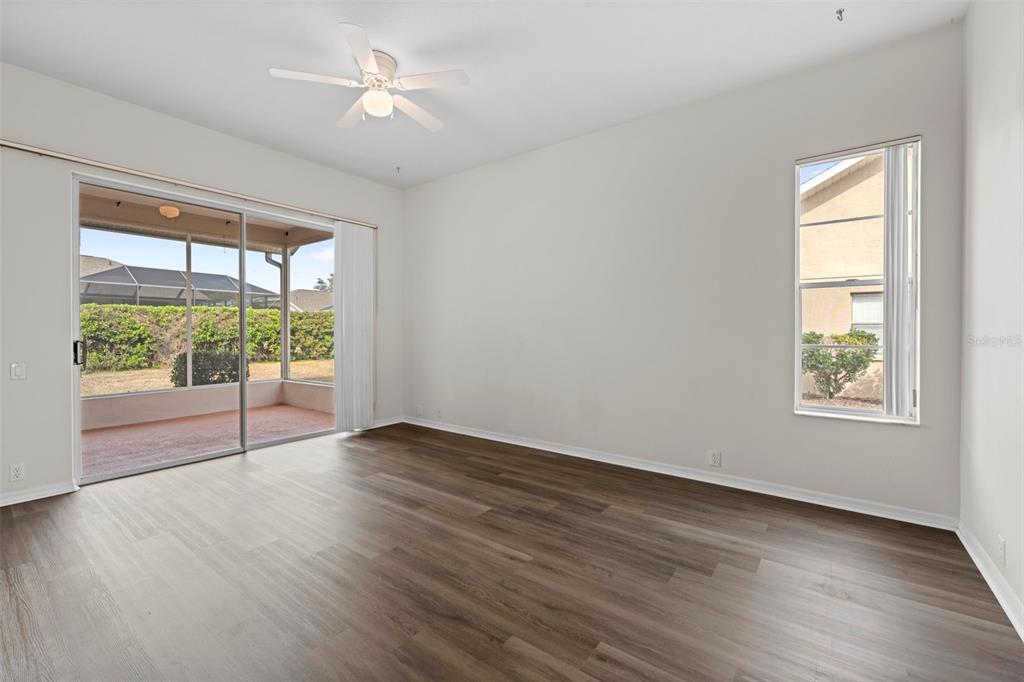 9369 Ashley Drive Weeki Wachee, FL 34613 - Photo 28 of 80 a view of an empty room with wooden floor and a window