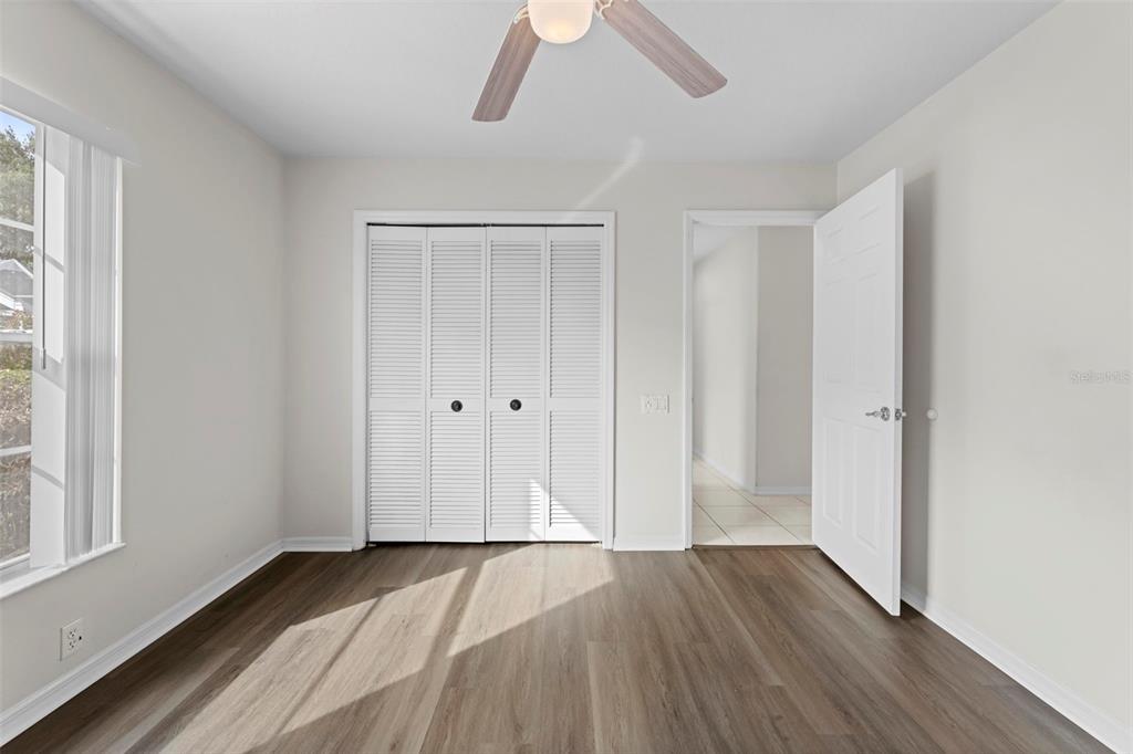 9369 Ashley Drive Weeki Wachee, FL 34613 - Photo 37 of 80 a view of empty room with wooden floor and window