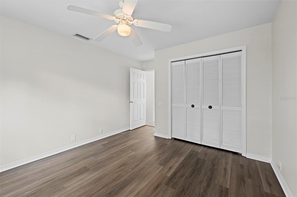 9369 Ashley Drive Weeki Wachee, FL 34613 - Photo 40 of 80 a view of an empty room with wooden floor