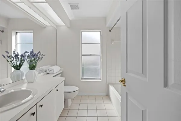 an aerial view of residential houses with outdoor space and lake view