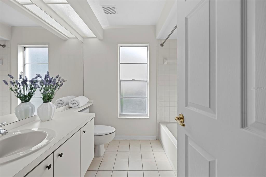 9369 Ashley Drive Weeki Wachee, FL 34613 - Photo 42 of 80 a bath room with a sink a toilet and a mirror