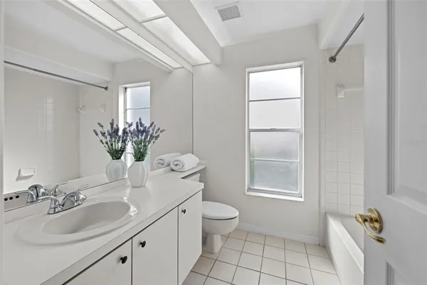 a view of a house with a big yard and potted plants