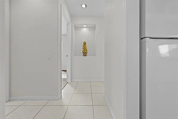 an aerial view of a house with a garden and lake view