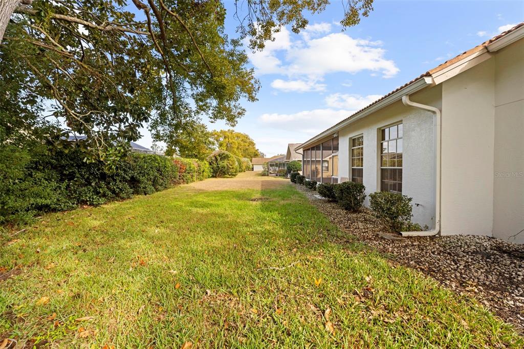 9369 Ashley Drive Weeki Wachee, FL 34613 - Photo 52 of 80 a view of backyard of house with green space