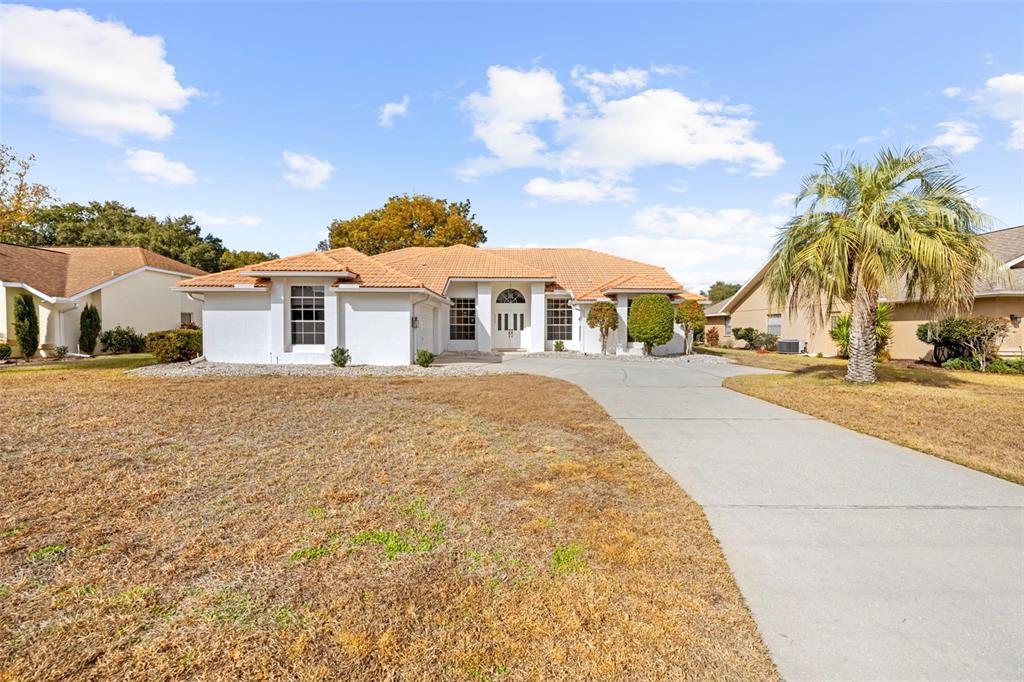 9369 Ashley Drive Weeki Wachee, FL 34613 - Photo 55 of 80 a view of a house with a yard