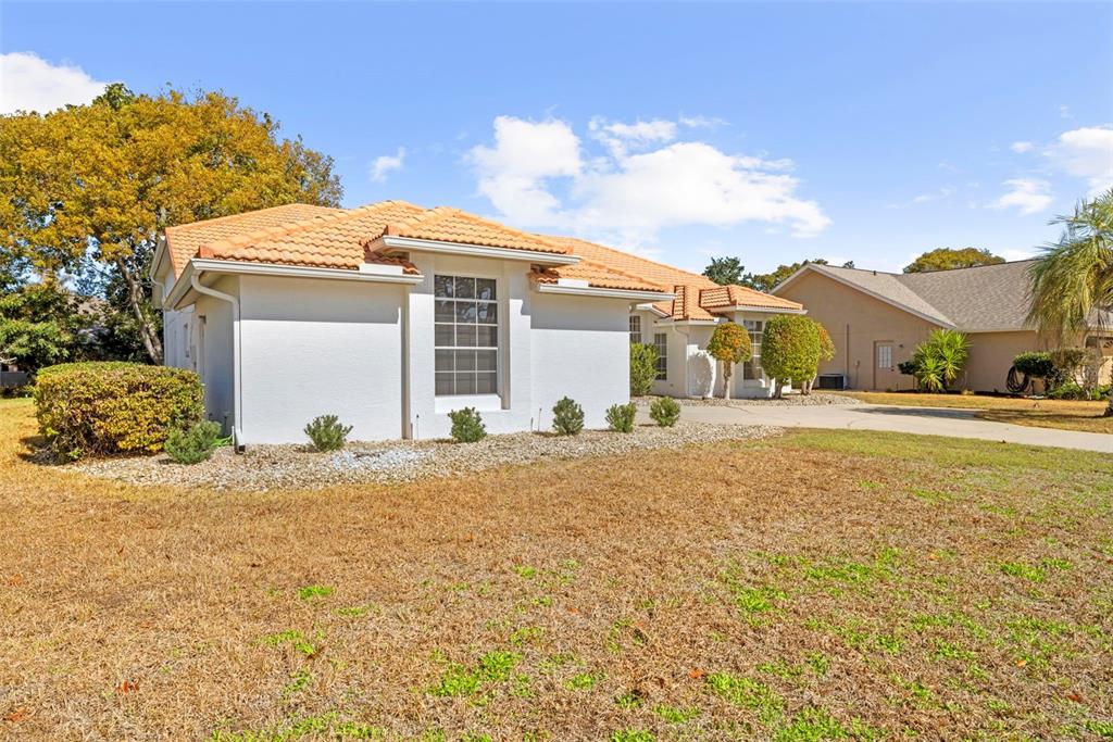 9369 Ashley Drive Weeki Wachee, FL 34613 - Photo 56 of 80 a front view of a house with a yard