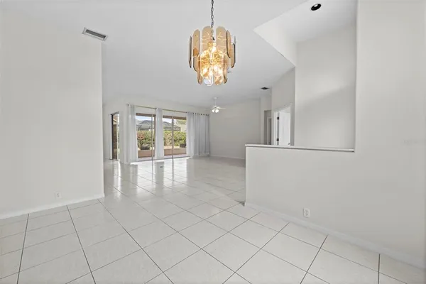 a kitchen with white cabinets and appliances