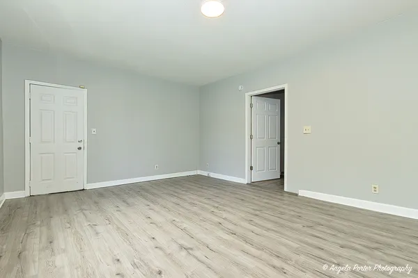 a view of an empty room and wooden floor