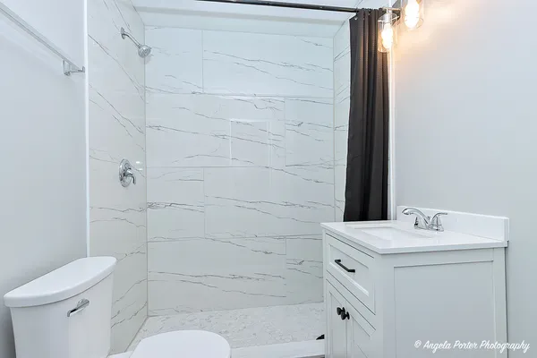 a bathroom with a sink toilet and shower