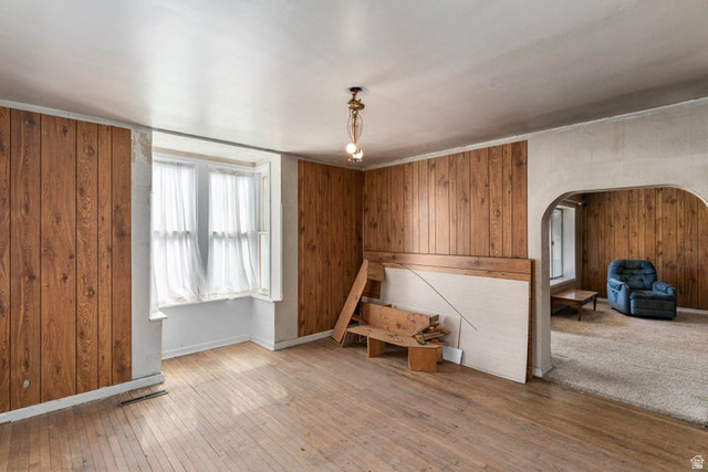 482 West 100 N Street Beaver, UT 84713 - Photo 22 of 41 Unfurnished great room featuring wood walls, arched walkways, and light wood finished floors